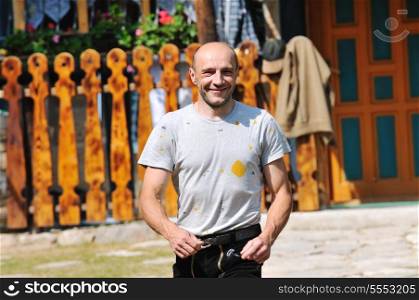 happy adult man walking outdoor with beautiful home in background