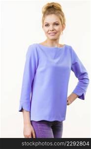 Happy adult woman presenting her casual beautiful outfit, blue long sleeved purple top and jeans.. Woman wearing casual outfit