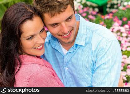 Happy affectionate couple hugging in blooming garden love romance embrace