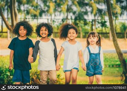 Happy African American boy and girl kids group playing in the playground in school. Children friendship and education concept.