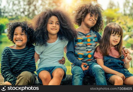 Happy African American boy and girl kids group playing in the playground in school. Children friendship and education concept.. Happy kids group playing in the park in school.