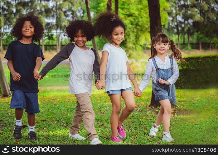 Happy African American boy and girl kids group playing in the playground in school. Children friendship and education concept.. Happy kids group playing in the park in school.