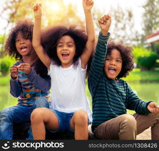 Happy African American boy and girl kids group playing in the playground in school. Children friendship and education concept.. Happy kids group playing in the park in school.