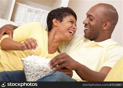 Happy African American Couple Eating Popcorn Watching Movie at Home