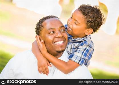Happy African American Father and Mixed Race Son Playing At The Park.