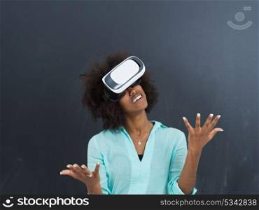 Happy african american girl getting experience using VR headset glasses of virtual reality, isolated on gray background