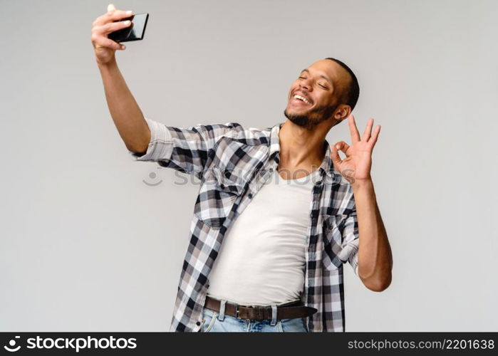 Happy african american man using mobile phone for video call.. Happy african american man using mobile phone for video call