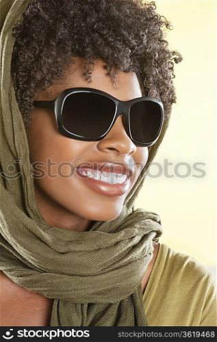 Happy African American wearing sunglasses with stole over her head