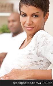 Happy African American Woman Couple Sitting At Home