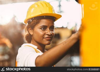 happy African American woman worker with safety suit helmet enjoy smiling working as labor in heavy industry factory with steel maχ≠operator for good welfare.