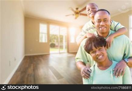Happy African American Young Family In Empty Room of House.
