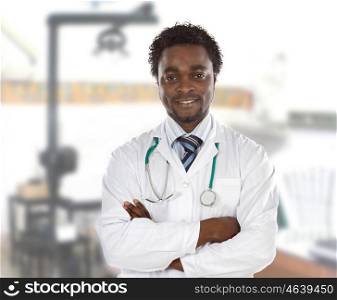 Happy african doctor at the hospital with crossed arms