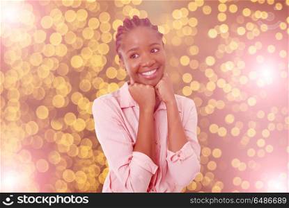 Happy african girl among christmas lights. happy girl