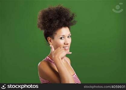 Happy African woman doing a call sign with her hand, over a green background