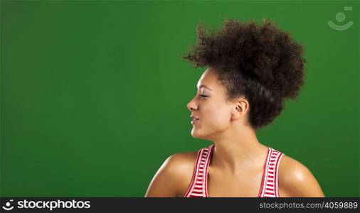 Happy African woman over a green background