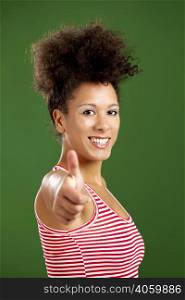 Happy African woman with thumbs up over a green background