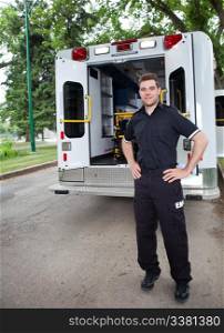 Happy ambulance driver standing for a portrait outdoors