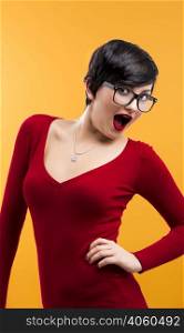 Happy and beautiful girl wearing nerd glasses, aganist a yellow background