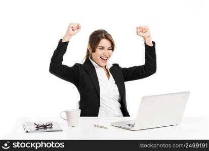 Happy and beautiful hispanic business woman in the office with arms up, isolated over a white background