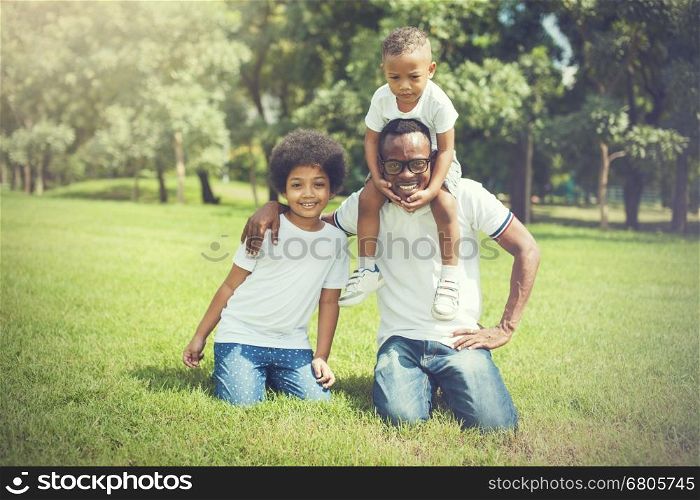 Happy and cheerful African American family of father, son and daughter.