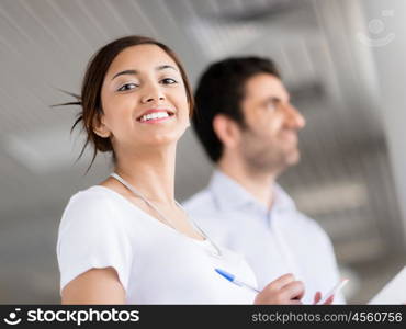 Happy and confident young woman in an office