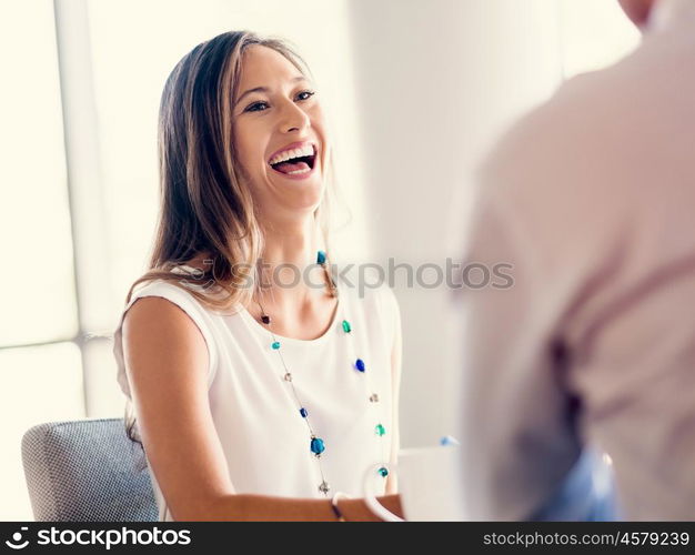 Happy and confident young woman in an office