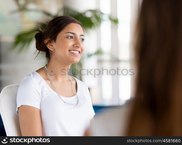 Happy and confident young woman in an office