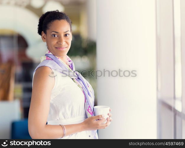 Happy and confident young woman in an office