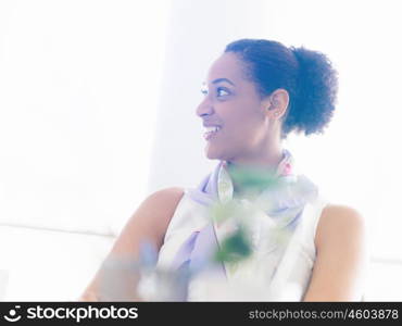 Happy and confident young woman in an office