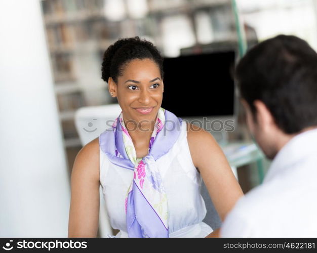 Happy and confident young woman in an office