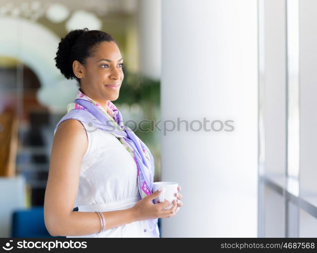 Happy and confident young woman in an office