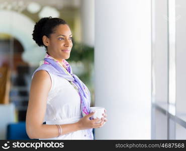 Happy and confident young woman in an office