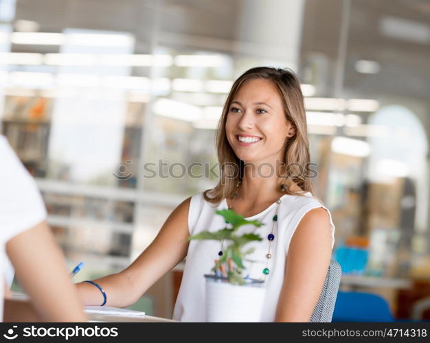 Happy and confident young woman in an office