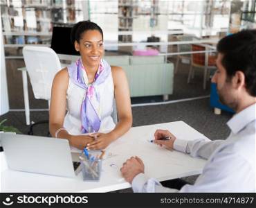 Happy and confident young woman in an office