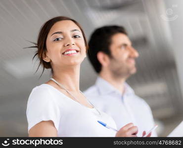 Happy and confident young woman in an office