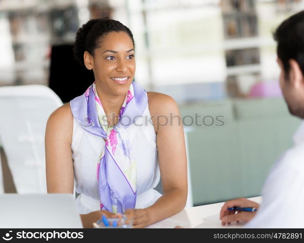 Happy and confident young woman in an office