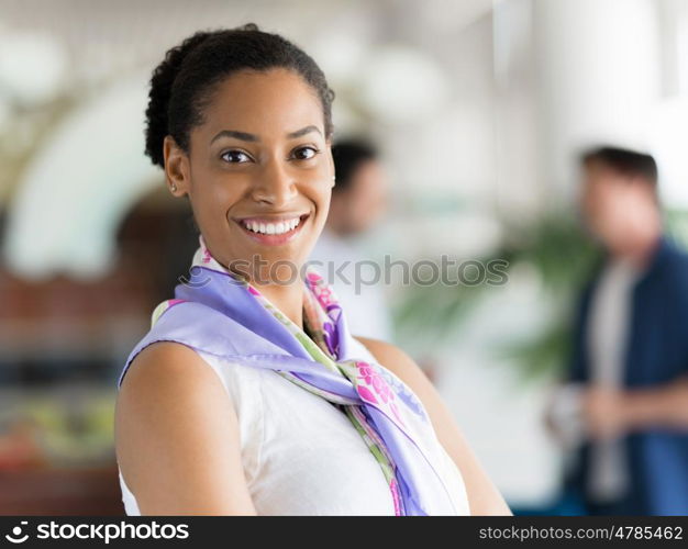 Happy and confident young woman in an office