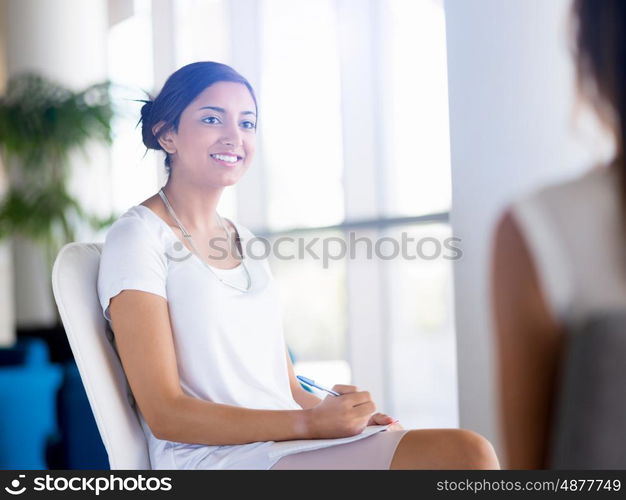 Happy and confident young woman in an office