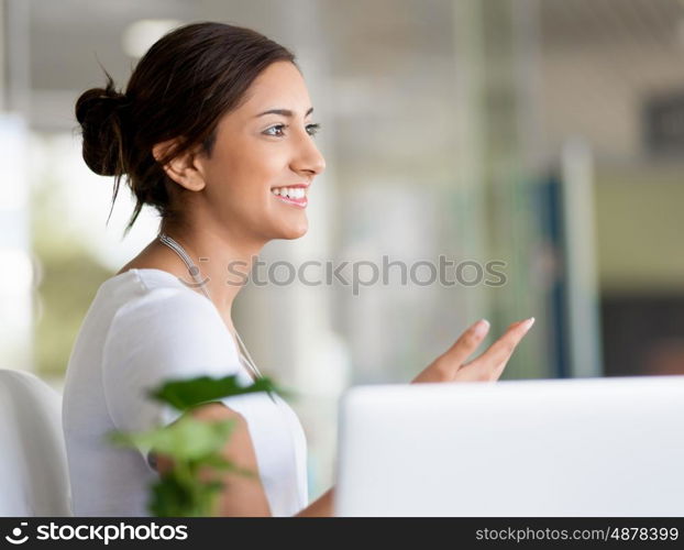 Happy and confident young woman in an office