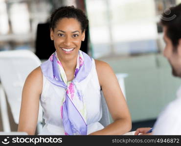 Happy and confident young woman in an office