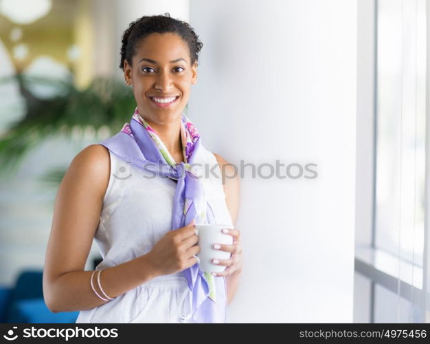 Happy and confident young woman in an office