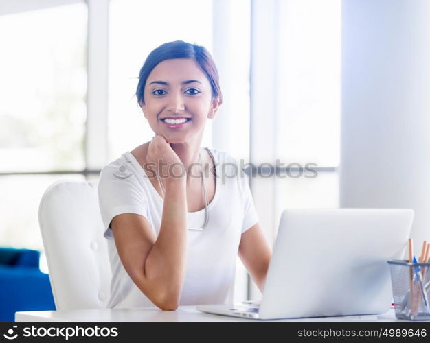 Happy and confident young woman in an office