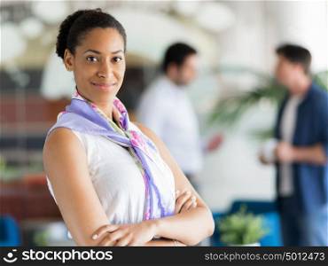 Happy and confident young woman in an office