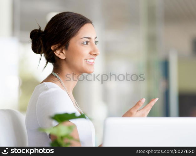 Happy and confident young woman in an office