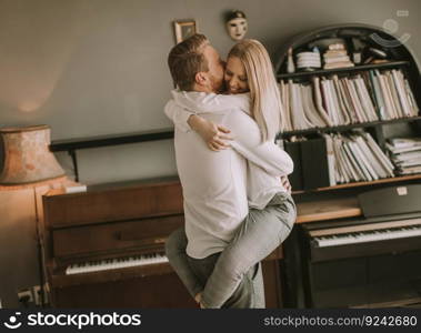 Happy and loving couple kissing in the room