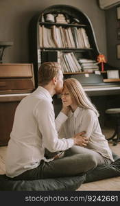 Happy and loving couple kissing in the room