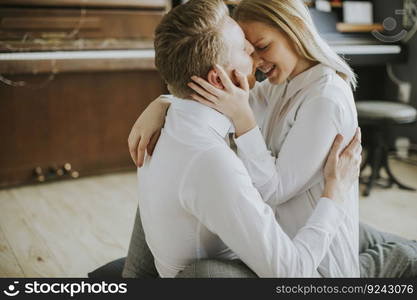 Happy and loving couple kissing in the room