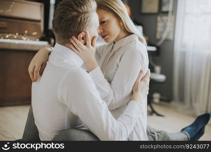 Happy and loving couple kissing in the room