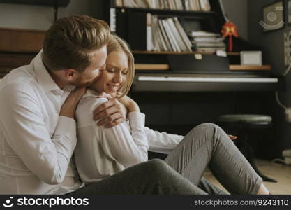 Happy and loving couple kissing in the room