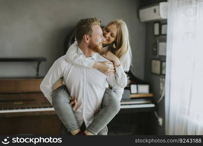 Happy and loving couple kissing in the room